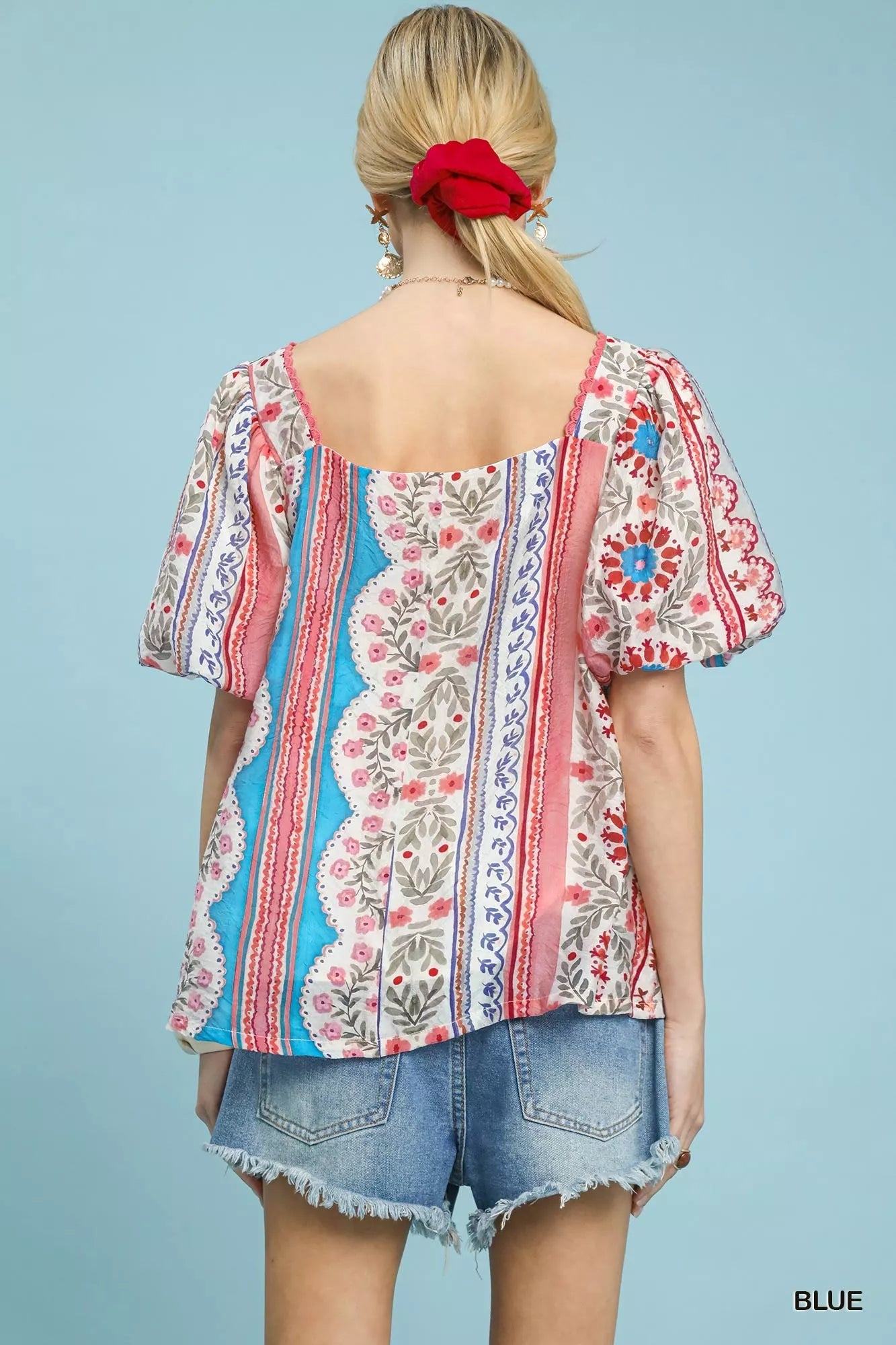 Back view of colorful patchwork puff sleeve blouse, denim shorts
