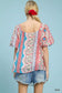 Back view of colorful patchwork puff sleeve blouse, denim shorts