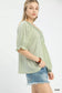 Side view of sage striped v-neck blouse at Blueberi Boutique