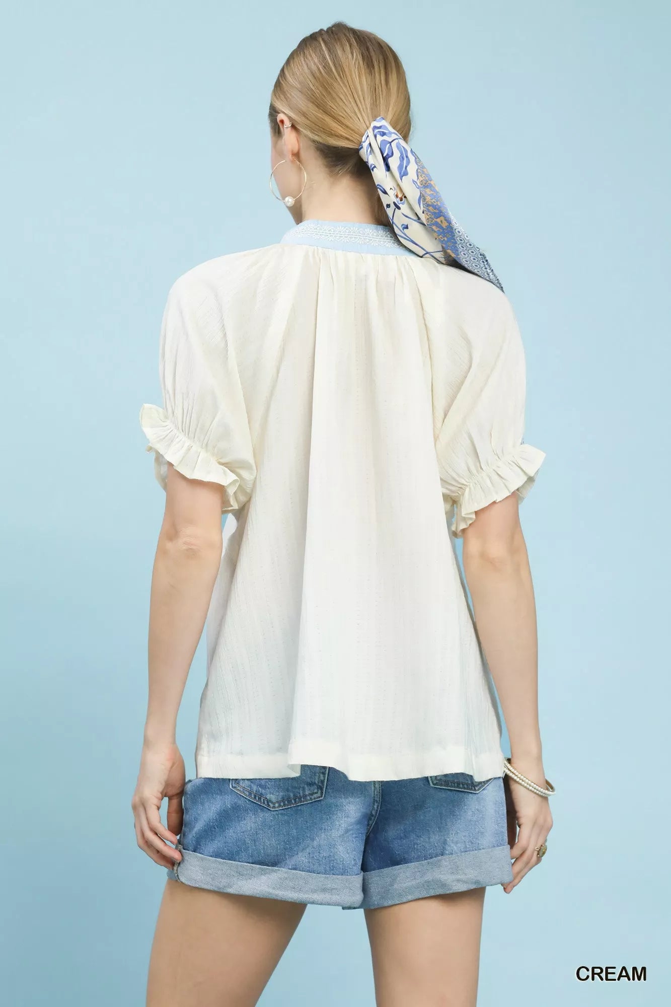 Cream textured v-neck top with lace trim details, short sleeves