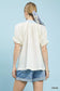 Cream textured v-neck top with lace trim details, short sleeves