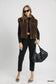Brown sherpa-lined zip vest with black outfit and bag at Blueberi Boutique