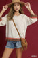 Blueberi Boutique Umgee scalloped hem color block top with brown coral trim, model adjusting wide hat