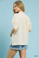 Back view of ecru textured puff sleeve blouse with denim shorts at Blueberi Boutique