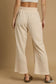 Woman from back wearing cream drawstring wide leg pants