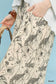 Close-up of Umgee two-tone floral pants with black botanical prints