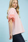 Umgee pink and white striped mixed puff sleeve blouse with coral puff sleeves, model in dark jeans