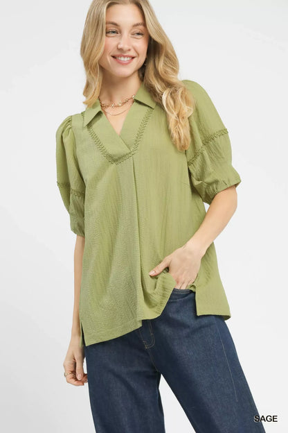 Umgee sage green puff sleeve top on model with jeans