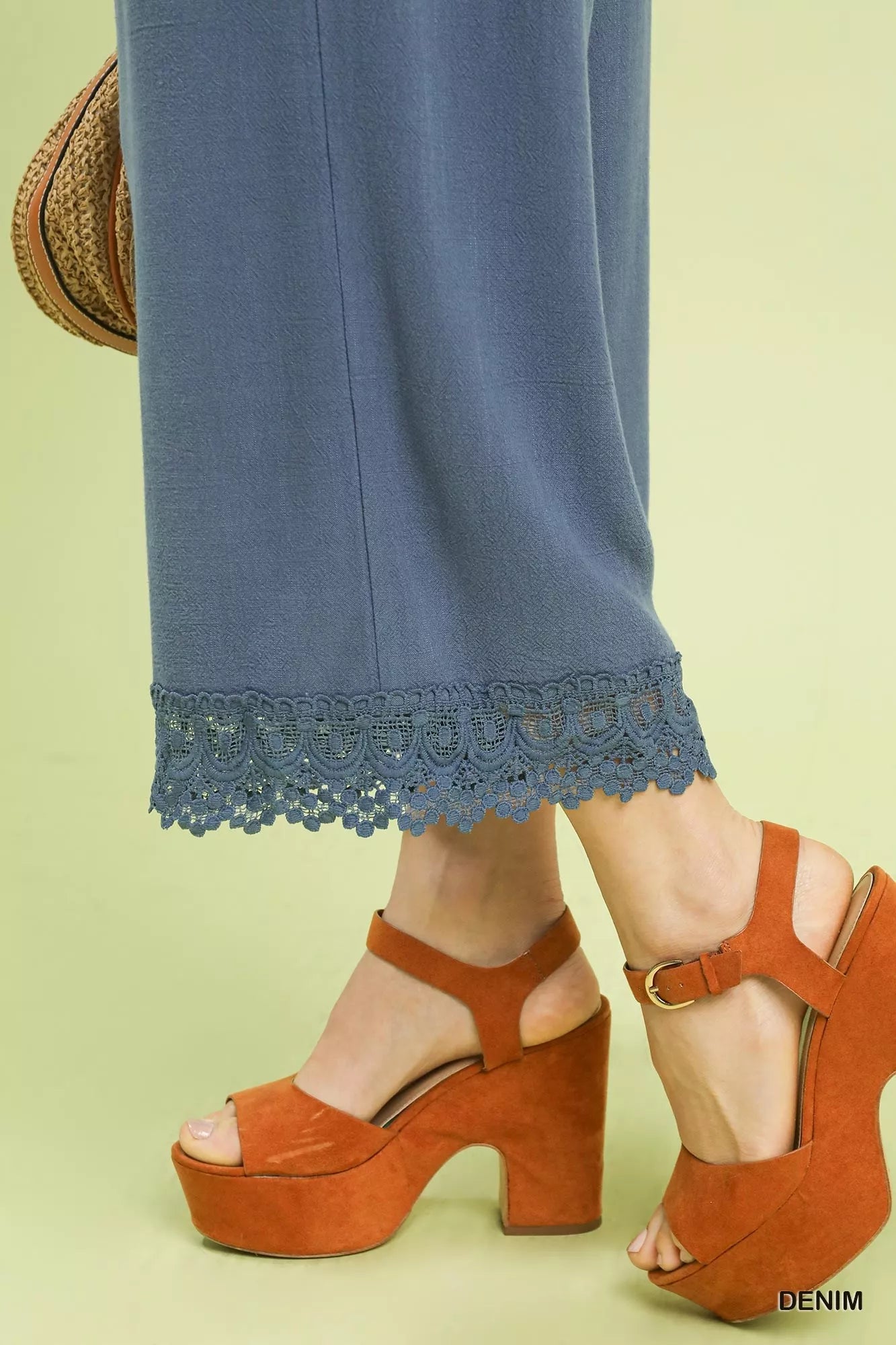 Close-up of Umgee linen wide leg cropped pants with lace trim detailing, paired with orange platform sandals