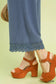 Close-up of Umgee linen wide leg cropped pants with lace trim detailing, paired with orange platform sandals