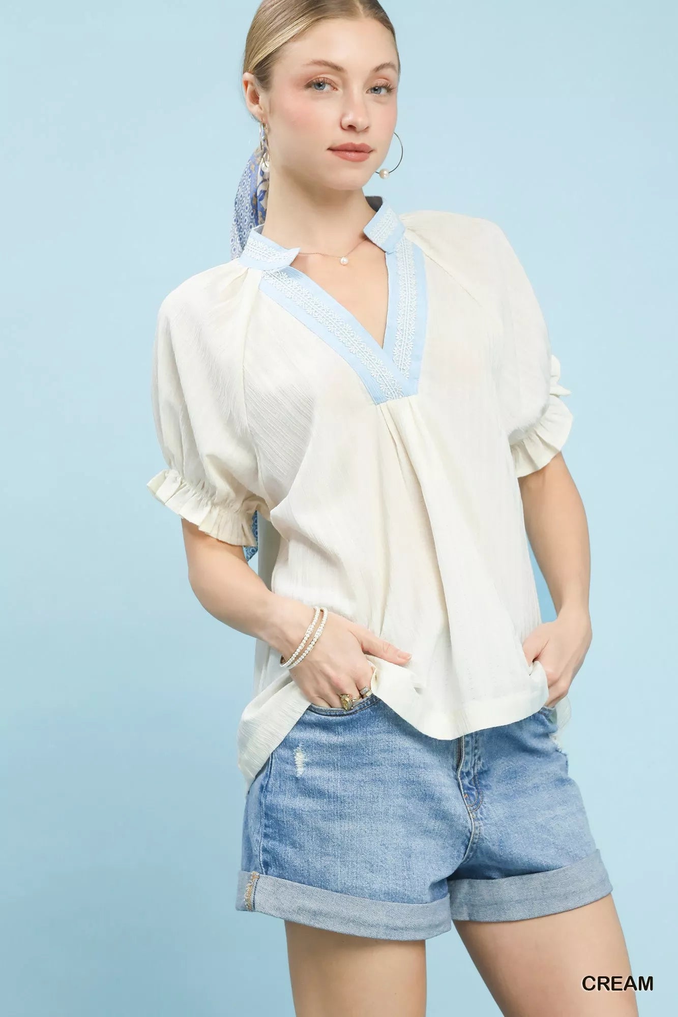Umgee cream textured v-neck short-sleeve blouse with lace trim details