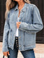 Person wearing a light blue denim jacket with a blurred background
