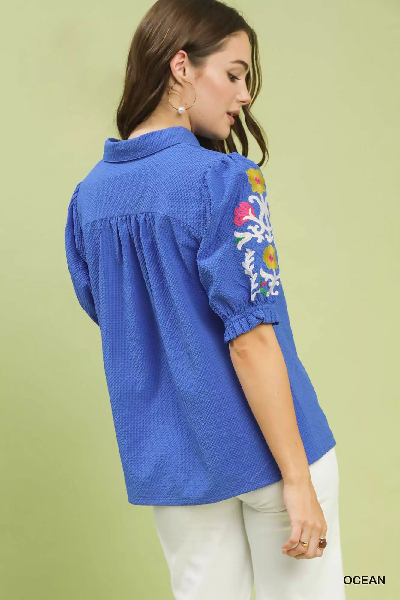 Back view of Umgee blue seersucker embroidered sleeve blouse with floral embroidery