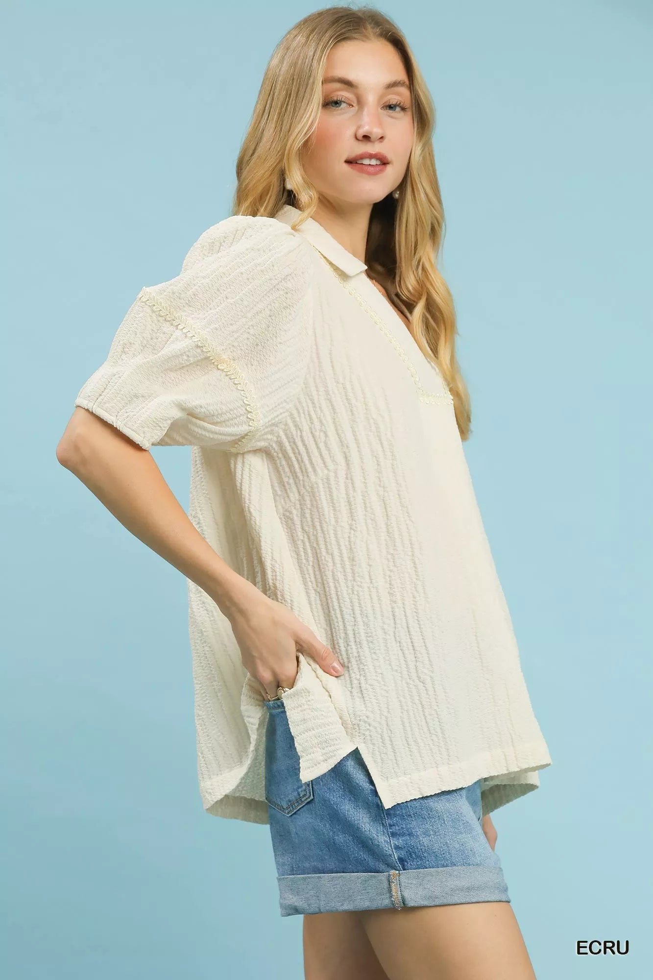Close-up of ecru textured puff sleeve blouse detail at Blueberi Boutique
