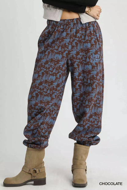 Umgee scenic print casual sweatpants (chocolate) with graphic, beige boots at Blueberi Boutique