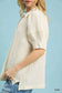 Close-up of ecru textured puff sleeve blouse detail at Blueberi Boutique