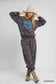Model adjusting beige knit beanie while wearing matching brown/blue scenic print casual sweatset - Blueberi Boutique