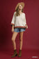 Blueberi Boutique Umgee oatmeal scalloped hem color block top with brown coral trim, model wearing brown ankle boots