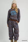 Umgee scenic print cropped sweatshirt with "APRÈS ALL DAY" text, matching printed casual pants & beige boots at Blueberi Boutique